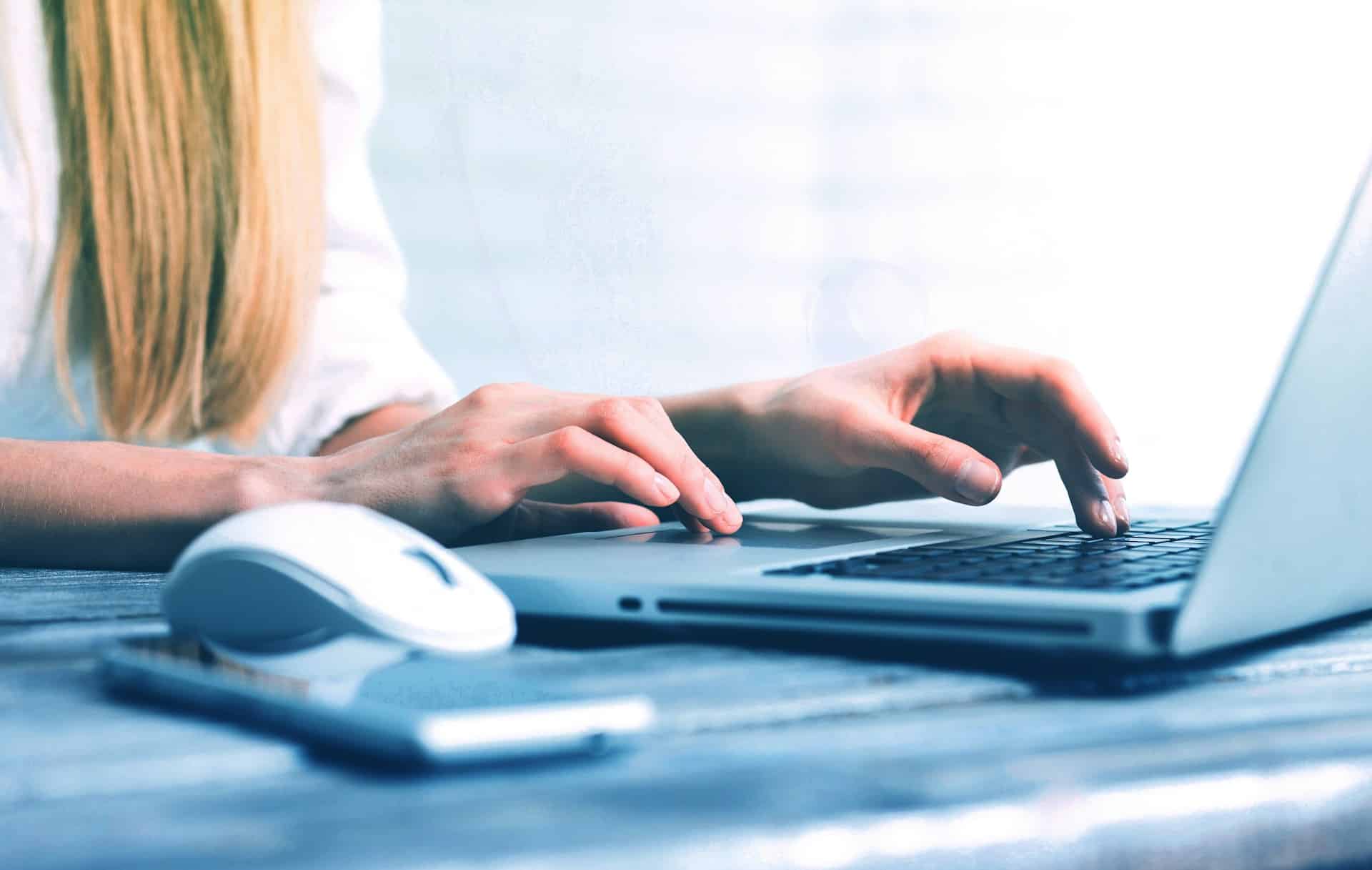 a woman typing on laptop