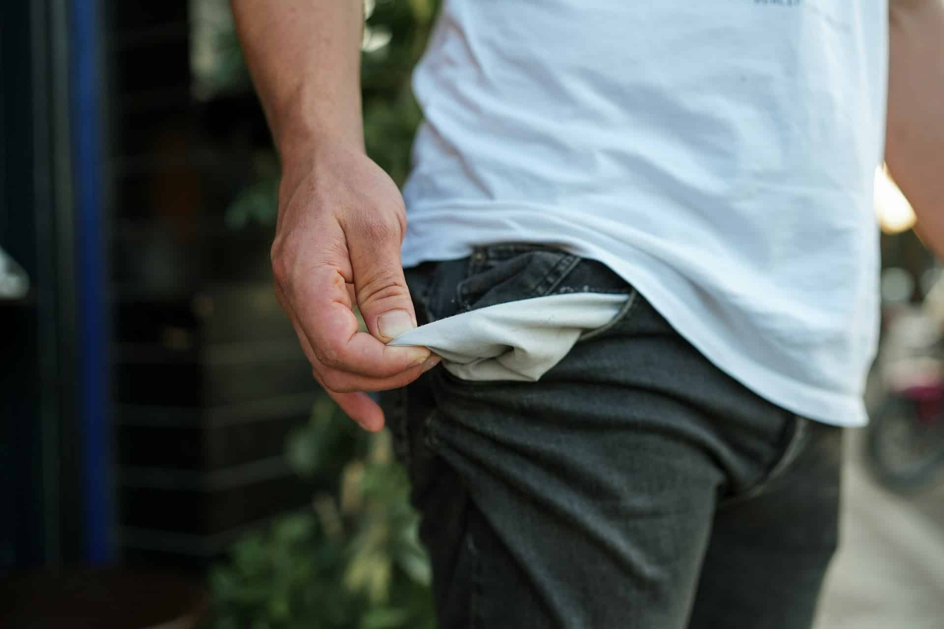 a close up of a person emptying their pant pockets