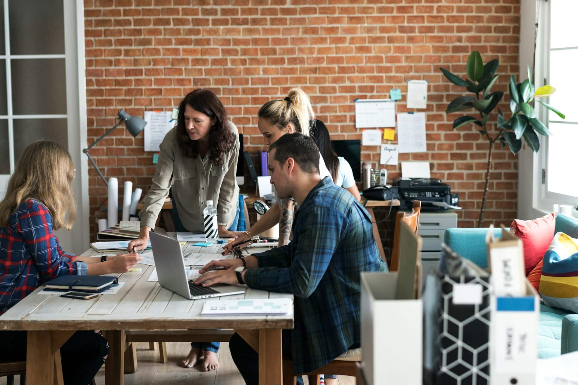 A group of employees meeting around a table, representing neurodiversity in the workplace.