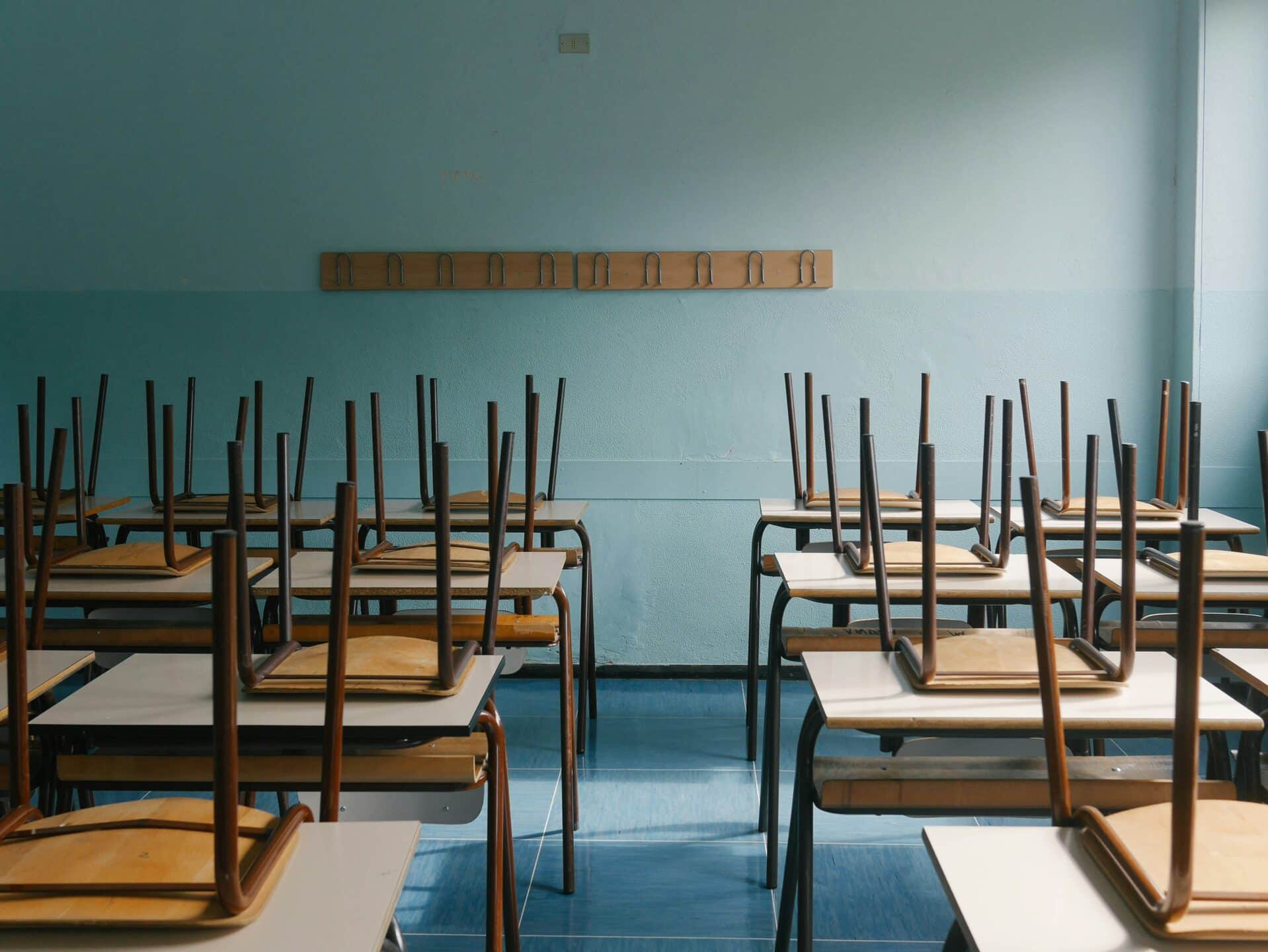 An empty classroom with chairs on the desks, representing duty to accommodate.
