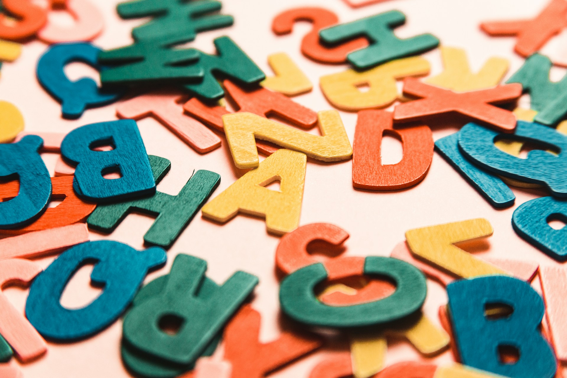 A close up of a number of wooden coloured letters, representing employment contracts and policies in the workplace.