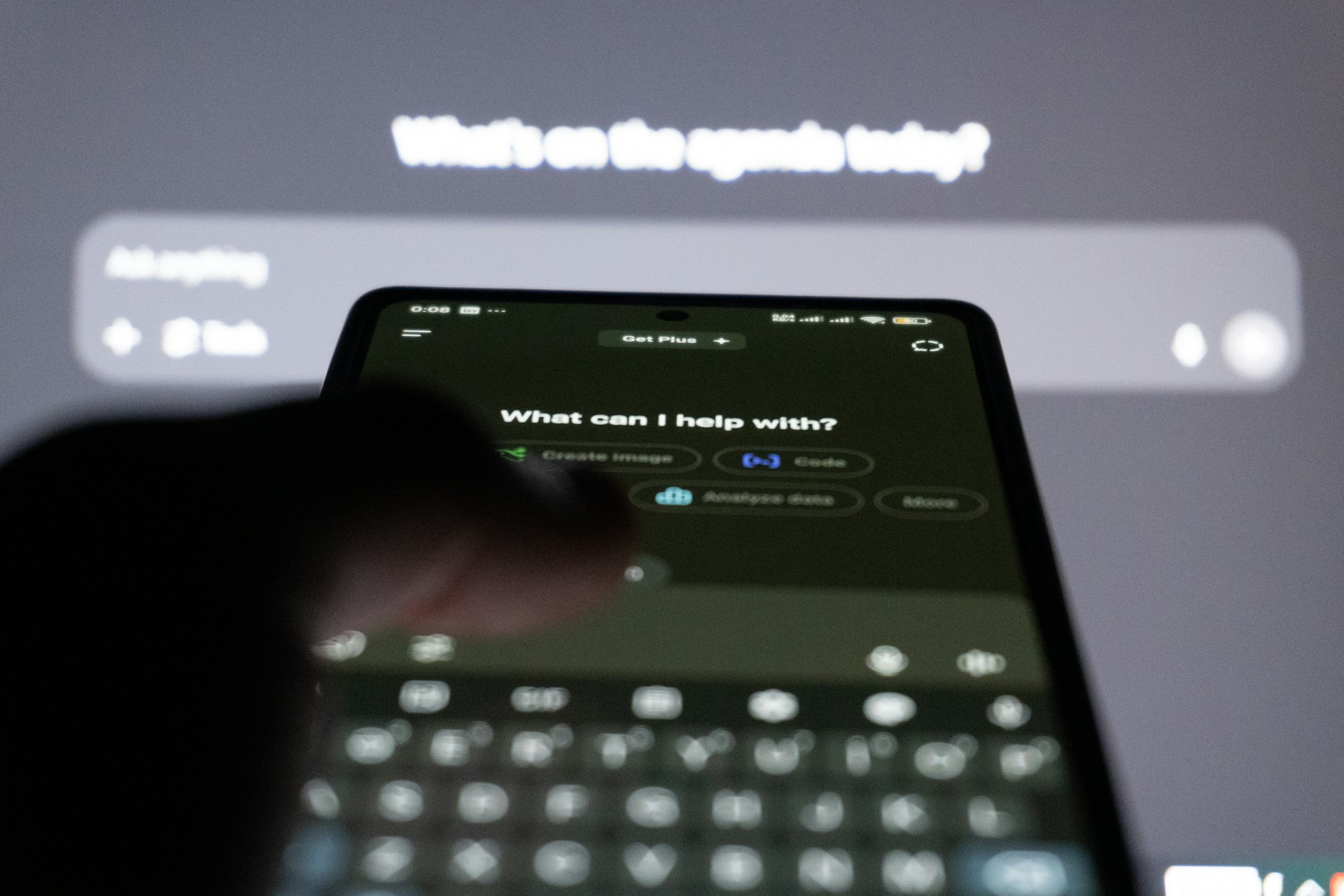 A person typing on a smartphone with an AI chatbot on the screen, representing workplace chatbots and confidential information.